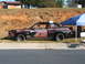 1971 Ford Ranchero - A modified car, likely for racing, sits parked on grass next to a blue canopy and a chair.