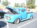 1971 Ford Ranchero - This blue pickup truck, likely from the 1950s, is displayed with its hood open, showing the engine compartment.