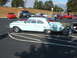 1971 Ford Ranchero - A light blue vintage sedan is parked in a lot with several other vehicles visible in the background.