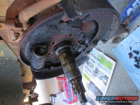 Rusty wheel cylinder and brake drum assembly with grease and debris