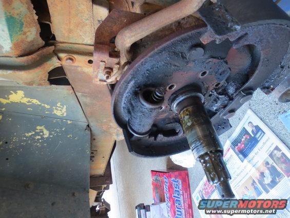 Wheel cylinder and brake drum assembly with visible splines and a newspaper