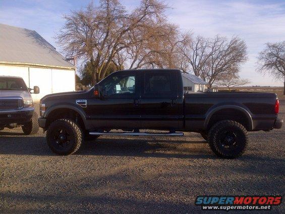 Black four-door pickup truck parked next to a silver pickup truck
