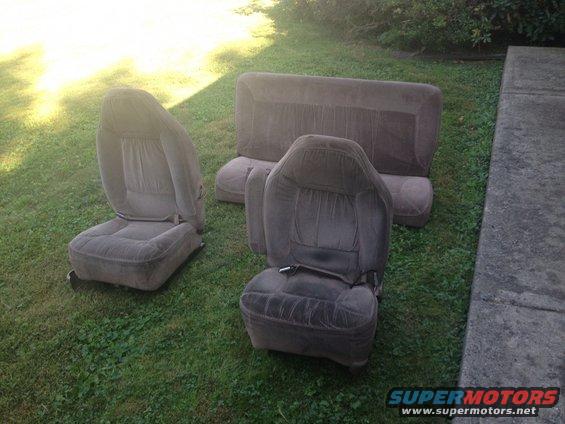 Gray cloth car seats and bench seat on grass