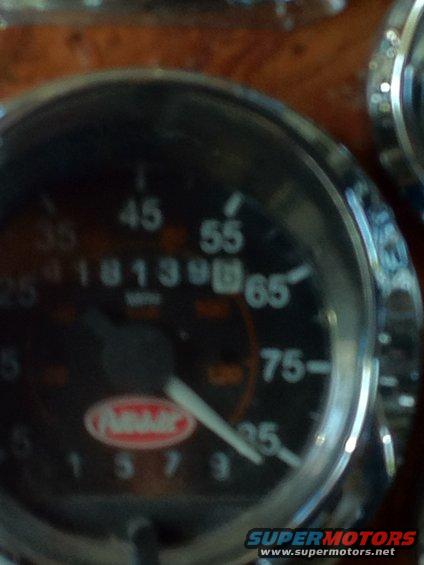 Close-up of a Peterbilt dashboard gauge with a needle pointing to 55 mph and odometer reading 181398