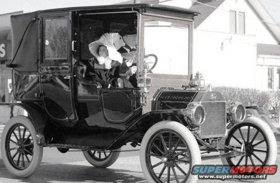 1912 Ford Model T town car with passengers inside