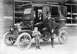 1912 Ford Model T - A family poses with their touring car in front of a store.