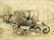 1914 Ford Model T - A vintage town car, possibly a taxi, with 'Street Line' visible on its side, navigates a wet street.