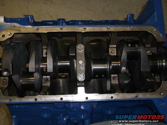 Blue engine block with exposed crankshaft and connecting rods