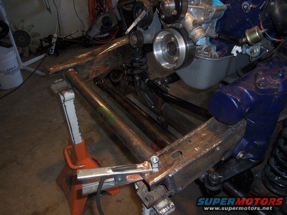 Vehicle frame with engine components and suspension parts, supported by jack stands