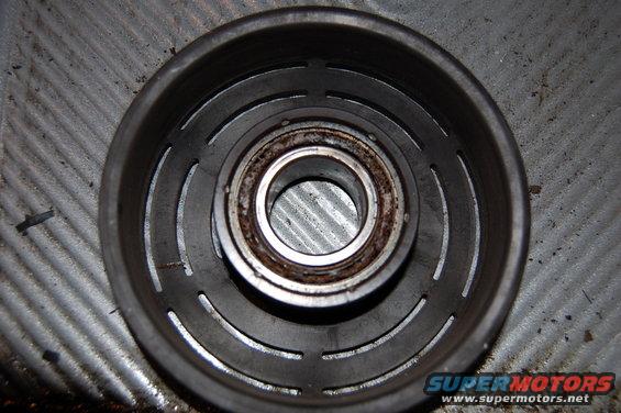 Backside of the clutch pulley. The shield fell off the bearing when it was removed. The grease has been baked to the point where it resembles dried mud.