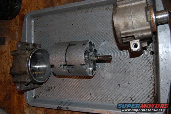 Case halves split, in the center is the piston and cylinder assembly.