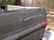 1970 Ford F-250 - The tailgate of a 1970 Ford F-250 Sport Custom shows significant rust and a damaged red taillight.