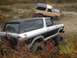 1970 Ford F-250 - Two Ford Broncos are parked on an off-road trail during the fall season.