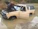 1970 Ford F-250 - A person checks the engine of a Ford Bronco submerged in water.