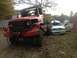 1970 Ford F-250 - A large red truck is parked next to a severely damaged white SUV in an outdoor setting.