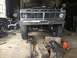 1970 Ford F-250 - This 1973 Ford F-Series truck is in a garage with its hood up, showing the front grille and suspension components, likely for maintenance o…
