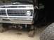 1970 Ford F-250 - Front view of a black Ford truck undergoing maintenance, showing its grille and suspension components.