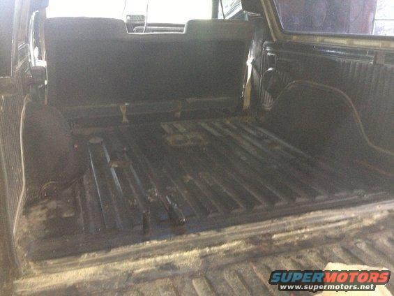 Interior of a truck bed, showing the floor and lower sides