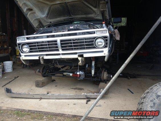 1970 Ford F-250 front end, hood open, undergoing repairs with bumper removed