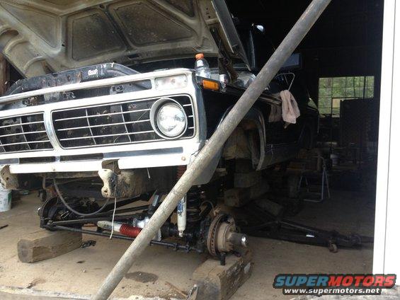 1973 Ford F-Series truck front end, hood open, undergoing repairs, raised on blocks