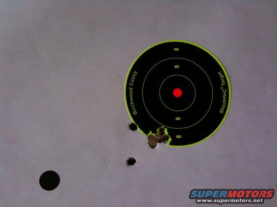 Birchwood Casey Shoot-N-C target with bullet holes and a black dot