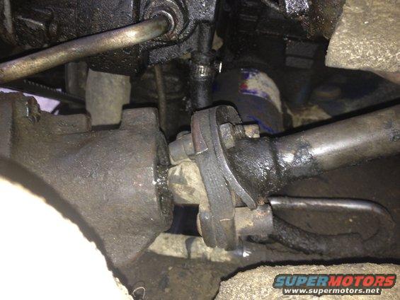 Close-up of greasy steering linkage components, possibly from a truck
