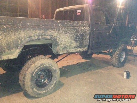 Side view of a 1970 Ford F-250 with mud splatter and lifted suspension