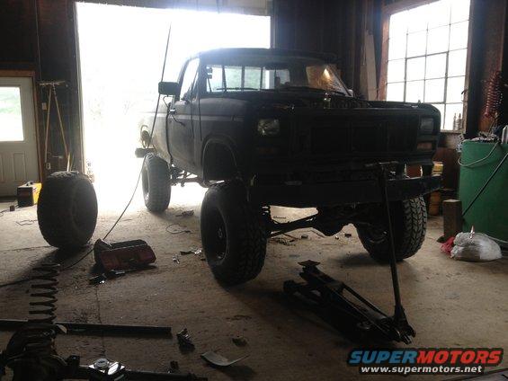 Black lifted pickup truck in garage, front view