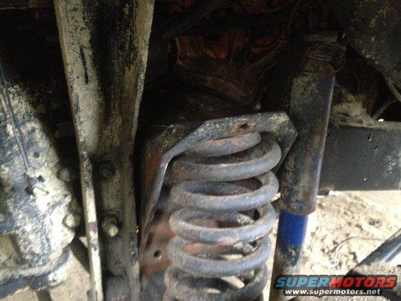 1970 Ford F-250 front suspension coil and shock absorber, heavily soiled