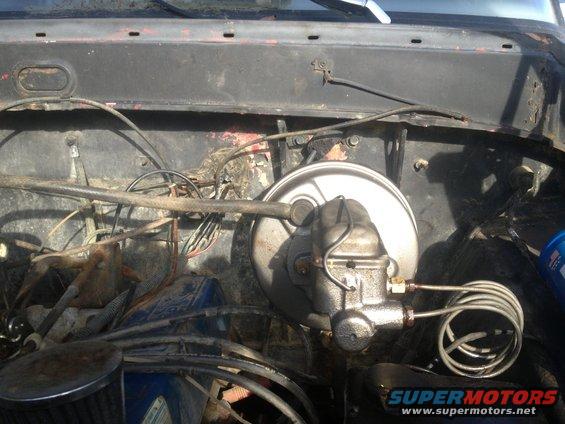 Engine bay view of brake booster and master cylinder