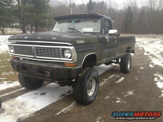 Black 1970 Ford F-250 truck, 3q-front view, lifted with large tires