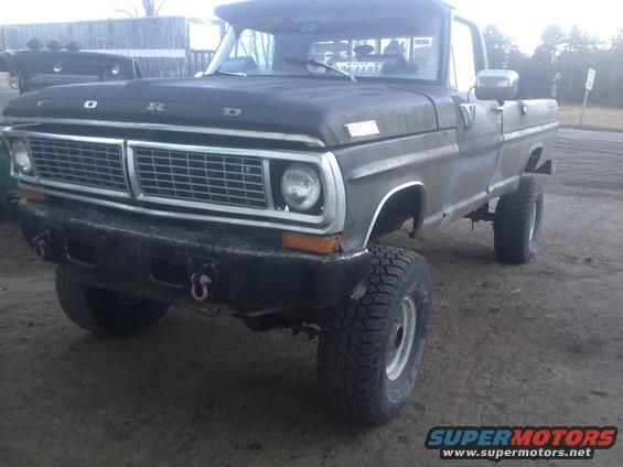 Ford pickup truck, front end visible, lifted suspension, off-road tires