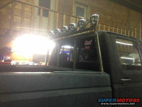 Truck bed with a custom light bar mounted above the cab. Stickers on the rear window include Summit Racing and Edelbrock