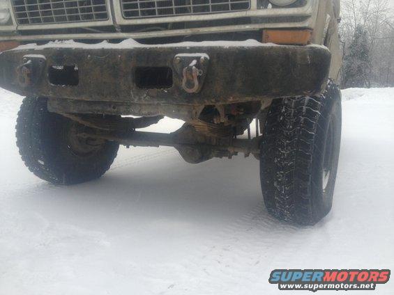 1970 Ford F-250 front bumper, grille, and suspension in snow