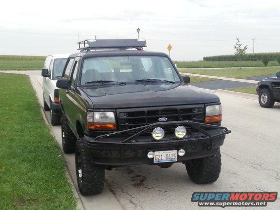 Black 1994 Ford Bronco front view with roof rack and aftermarket bumper
