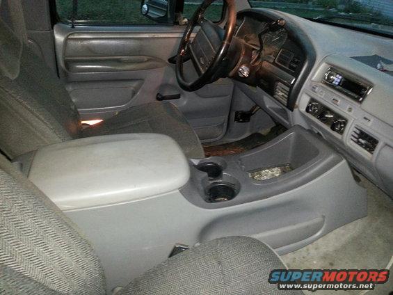 Gray fabric seats and center console with cup holders in a 1992 Ford F-150 interior