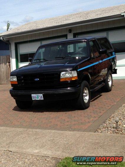 Black 1992 Ford Bronco parked in driveway in front of garage