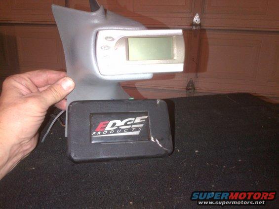 Edge Products tuner with display and control buttons, held by a hand