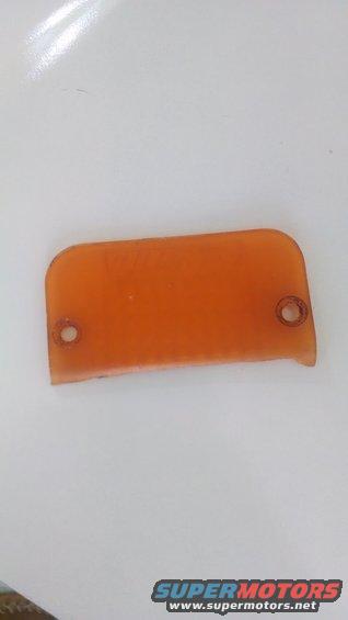 Orange plastic rectangular part with rounded corners and two screw holes