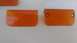 1995 Ford Bronco - Two orange plastic marker lights are shown against a white background.