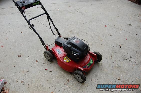 Red Toro Recycler lawn mower with black handle and engine