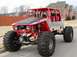 1988 Ford Bronco - This custom-built buggy features a prominent red roll cage and oversized tires for off-road use.