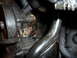 1995 Ford Thunderbird - This image shows a close-up view of a vehicle's power steering pump and associated hoses, with visible signs of wear and oil residue.