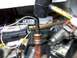 1998 Ford Crown Victoria - A close-up view of a distributor cap and rotor, surrounded by various tools and automotive parts.