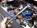 1998 Ford Crown Victoria - Workbench cluttered with tools and a car part, including a distributor and a metal shaft.