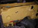 1972 Ford Ranchero - The firewall of a 1972 Ford Ranchero, painted yellow, shows its construction with numerous rivets and openings.