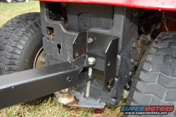 Rear hitch attachment on a red riding mower