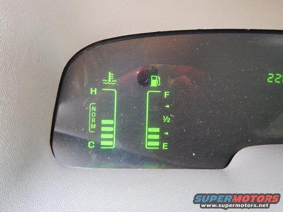 Dashboard gauges showing fuel and temperature levels, with a digital readout of 225