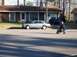 1990 Ford Bronco - A person rides a pocket bike down a residential street in front of a house.