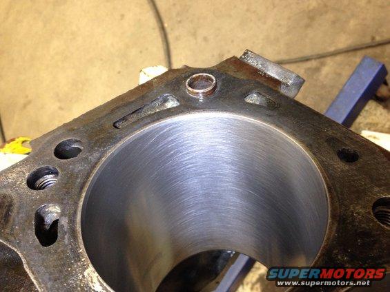 Close-up of an engine cylinder block with visible honing marks inside the cylinder bore